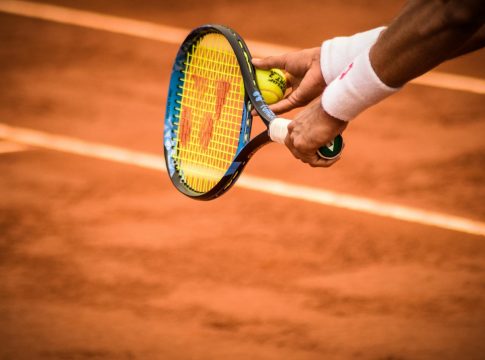 Photo by Gonzalo Facello Close-Up Photo of Person Holding Tennis Racket and Ball